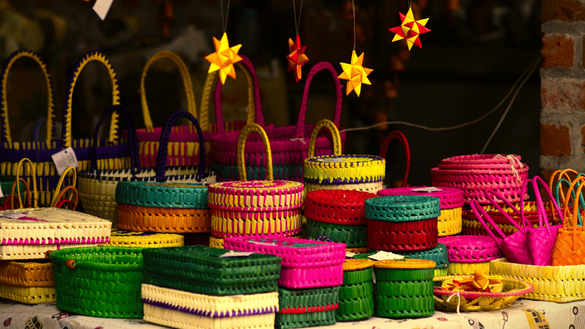 Colourful handcrafted baskets, woven boxes, and decorative souvenirs displayed at a local market in Goa.