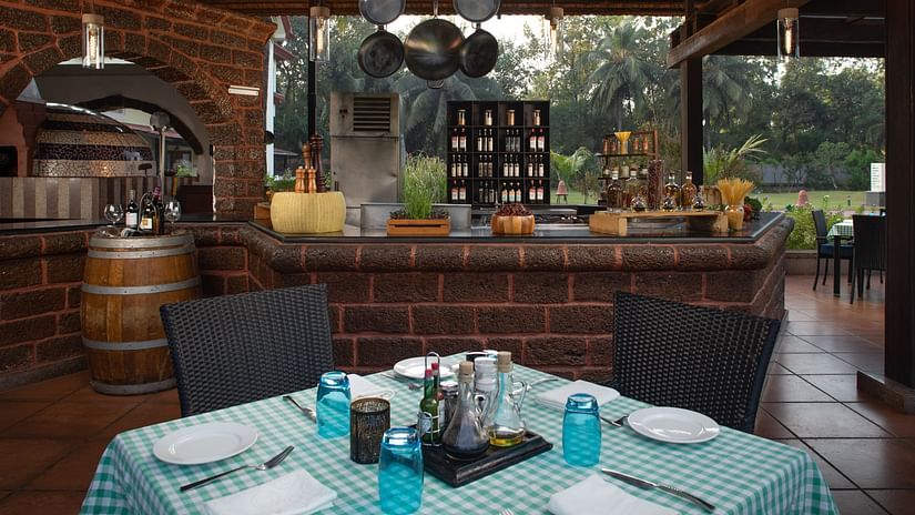 Salute, our Italian restaurant looks serene and friendly with its pleasing interiors and open view to nature - Kenilworth Resort and Spa