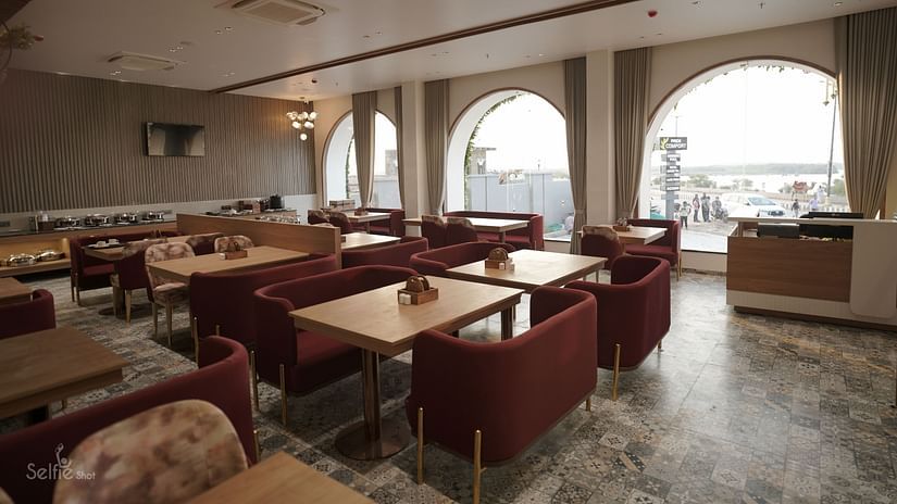 Seating arrangement in the restaurant at Pride Comfort, Dwarka