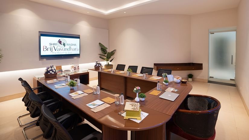 Modern conference room with a projector screen and comfortable seating at Shri Radha Brij Vasundhara Resort & Spa, Mathura