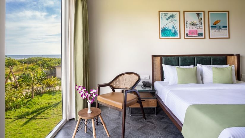 Premium Suite that features a queen size bed along with an arm chair with beautiful views from the window besides it