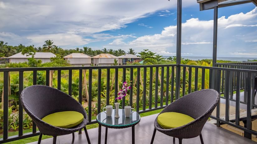 private balcony featuring two chairs along with a coffee table with beautiful views from the balcony