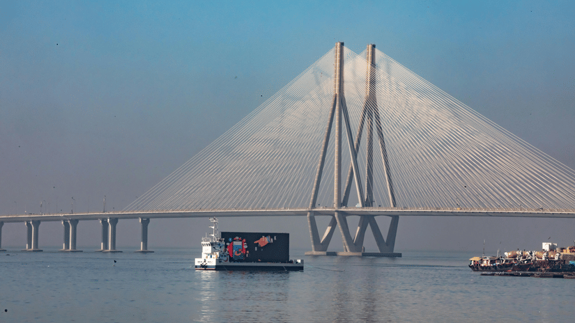 Boats sailing across the water with the Bandra–Worli Sea Link visible in the background.