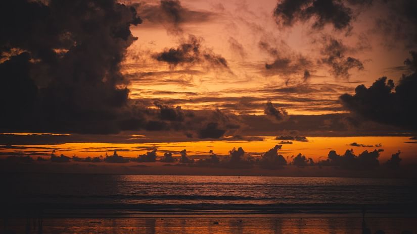 a serene beach in Mumbai with purple clouds