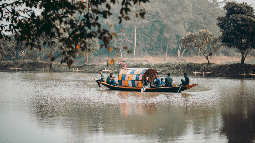 traditional shikhara lake surrounded by trees and lush green trees.