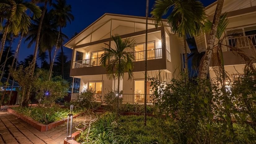 Facade image of VITS Select Casuarina Diveagar with greenery around it during the night