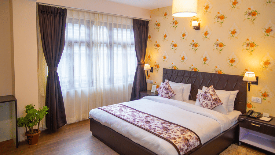 Dream Villa Retreat, Pelling - The king size bedding placed next to the decorated wall in the bedroom
