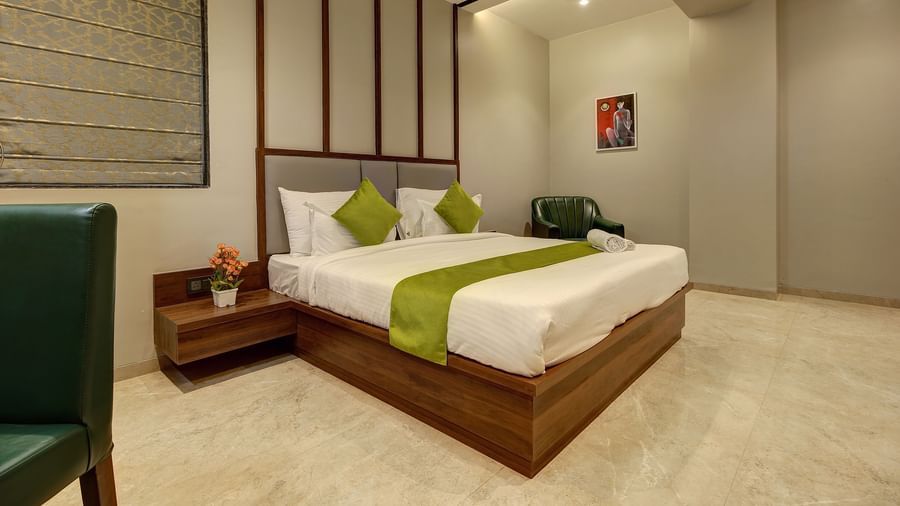 A double bed with side tables inside Luxury Suite - Fortune House, Magarpatta
