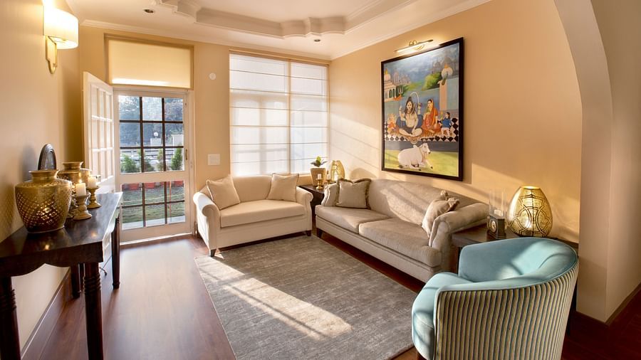 An image of a living room features comfy sofas and large windows 4 - Lamrin Boutique Cottages Rishikesh