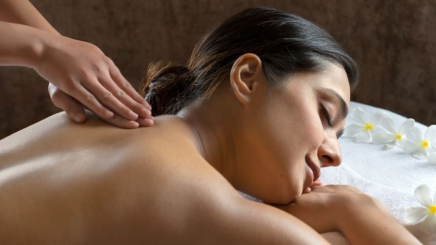 A side view of a woman getting massage at a spa.