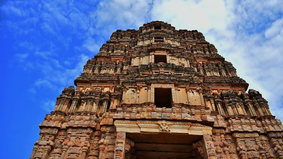 A stunning low-angle shot of a temple with intricate architecture set against the backdrop of a cloudy sky - Hotel near Tirupati temple