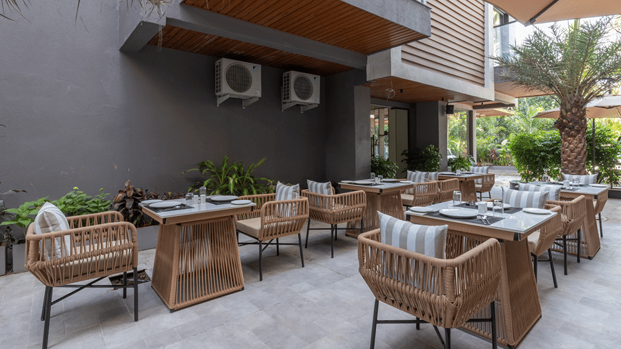 Outdoor courtyard café with rattan seating and dining tables set for outdoor dining at Sibaya Courtyard By Stone Wood Premier.