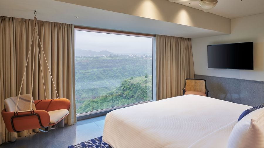 Image of a room with a bed and a large window in front overlooking the valley - The Dukes Retreat, Khandala