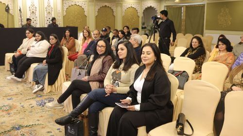 Couple of people sitting in a hall with soft lighting.- Heritage Village Resorts & Spa