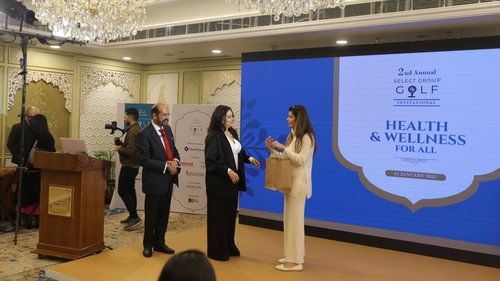 An image of a women receiving some accolade in a stage at Heritage Village Resorts & Spa