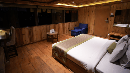 Comfortable wooden room with a queen-size bed and mountain view