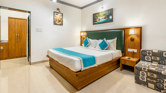 Bedroom with wooden bed, blue and white bedding, and artwork on the wall at Nature Trails Durshet