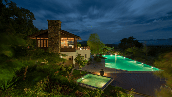 our resort with swimming pool in Bandipur lit up at night