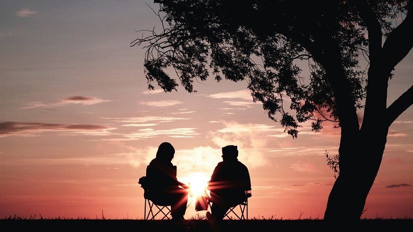 couple sitting under tree