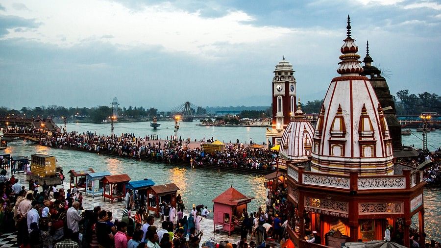 Temple surrounded by river on all sides. A huge crowd has gathered to attended the religious ceremony.