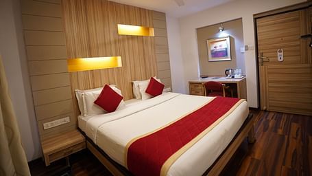 an image of a deluxe bedroom with a fan hanging from the ceiling at City Centre Residency