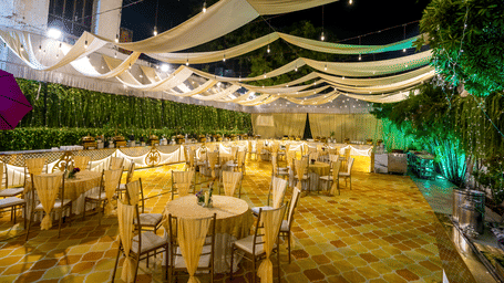 Lawn of Gemini Continental featuring banquet tables, elegant drapes, and a long buffet line under warm festive lighting.
