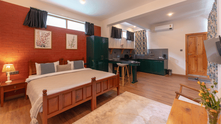 Full view of a studio suite including the bed, seating area, and open-plan kitchenette - Johnson Lodge & Spa, Manali