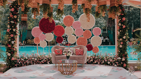 A decorated space with a sofa in the centre and balloons above it - Karma Lakelands.