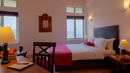 bed and a work station at one of the rooms in Cherrapunjee