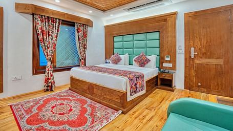 Cosy guest room with traditional decor and modern comfort at Royal Comfort Regency, designed for a peaceful and elegant stay.