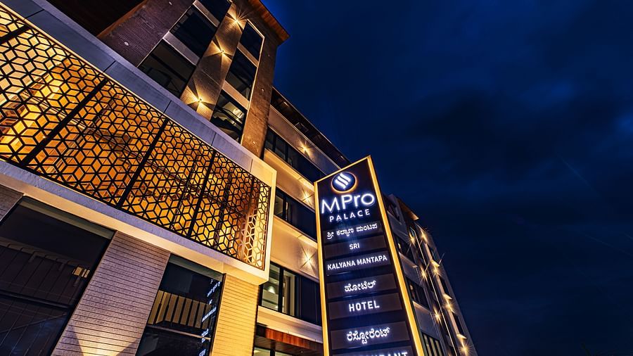 The facade of M Pro Palace featuring a signboard.