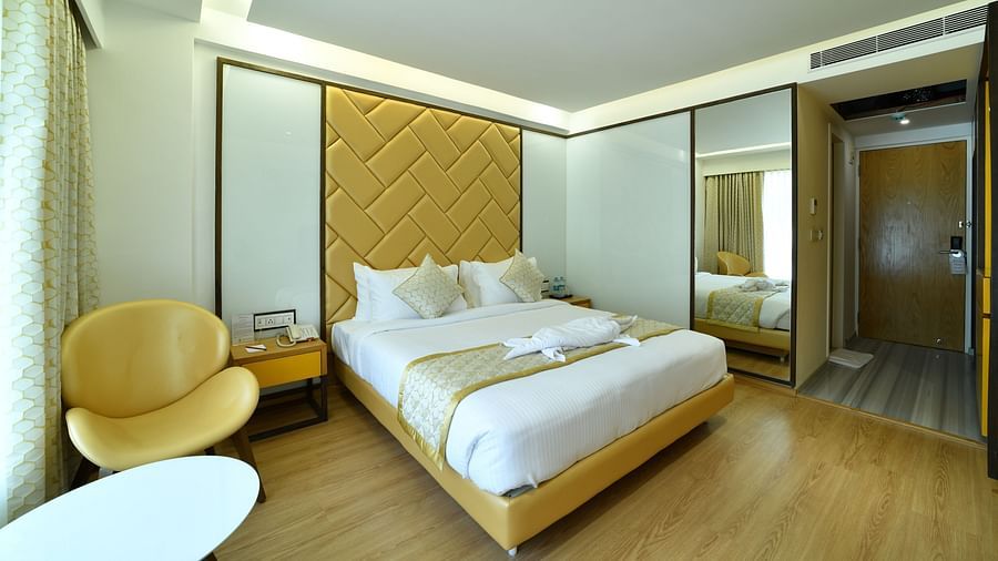 President Kumara Park, banglore  A corner view spacious bedroom with modern chair , table.