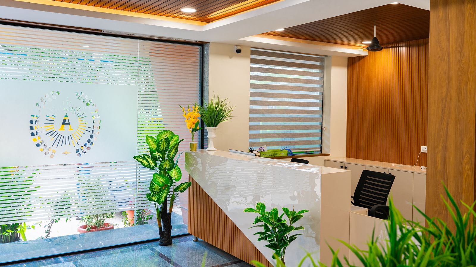 An image f a reception area that has a high desk and a chair near it - Hotel Aerotel, Hyderabad - A Unit of Comfort Hometel