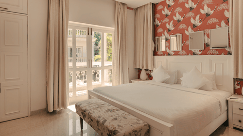 Spacious and well-lit bedroom with a balcony at Three BHK Premium Villa, Richmonde Ananta Elite, Goa.