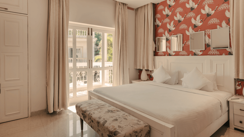 Spacious and well-lit bedroom with a balcony at Three BHK Premium Villa, Richmonde Ananta Elite, Goa.
