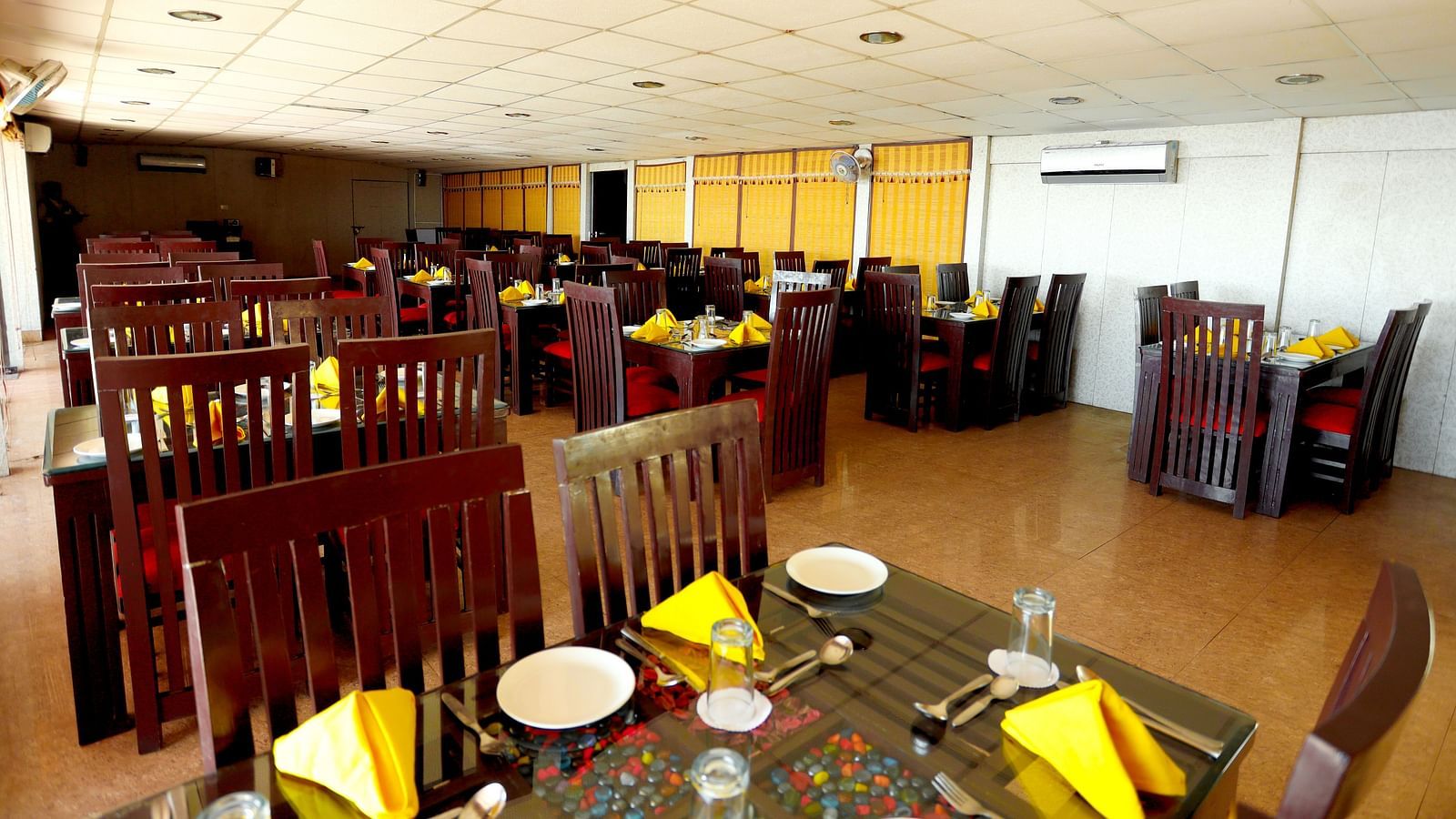 Image of a table with napkins arranged on the table at Amara Hill Queen, Mussoorie.