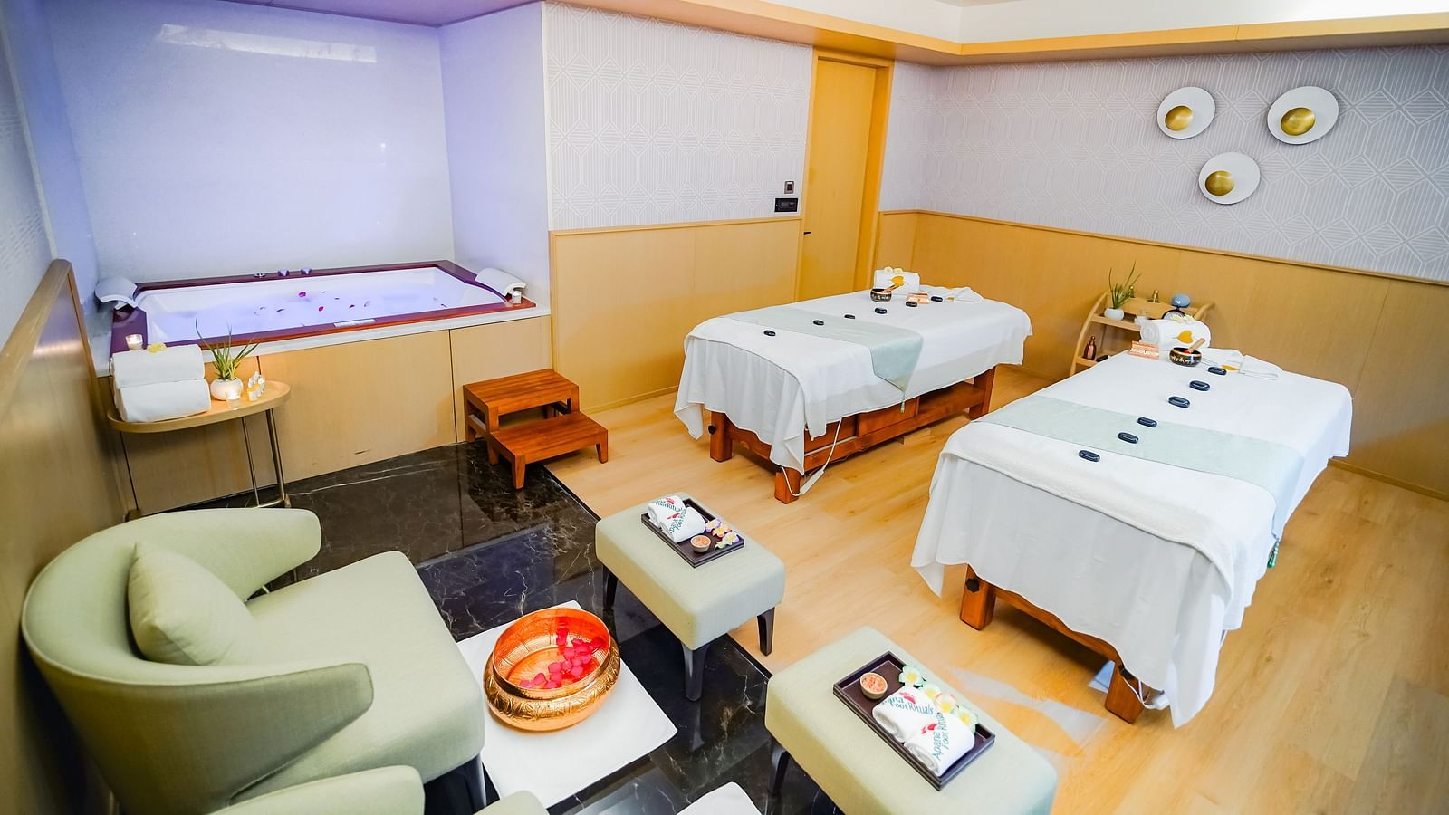 A treatment room in Bodhi Spa in Madurai with comfortable furniture and bath tub to relax in - Grand Madurai by GRT Hotels