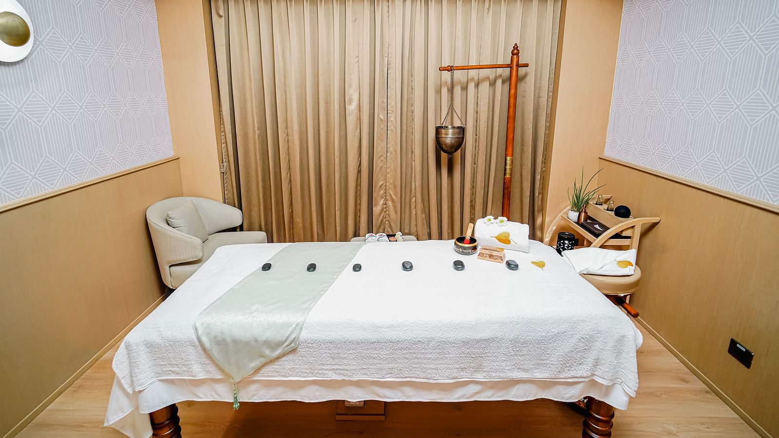 A peaceful Bodhi spa treatment room with a massage table set up for a relaxing experience - Grand Madurai by GRT Hotels