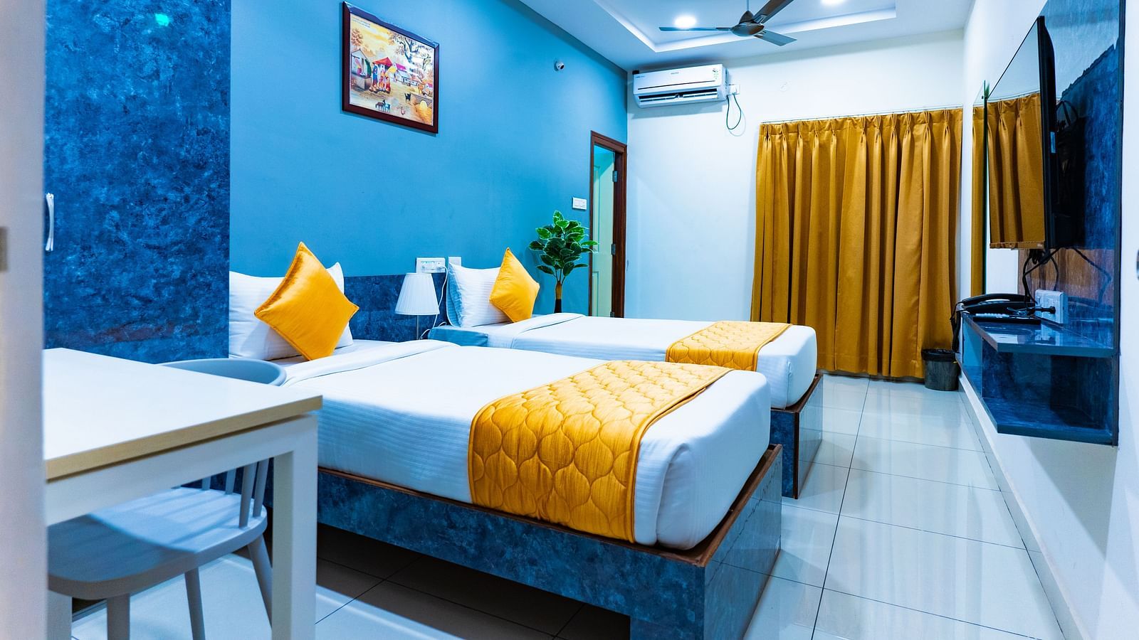 An image of a bedroom with twin bed, bedside table next to it, AC, flat TV screen, etc. - Hotel Aerotel, Hyderabad - A Unit of Comfort Hometel