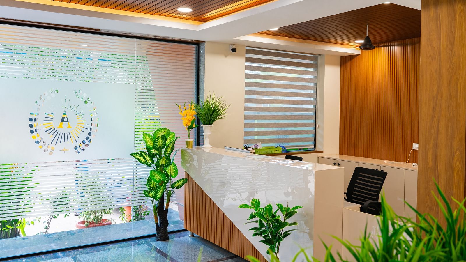 An image f a reception area that has a high desk and a chair near it - Hotel Aerotel, Hyderabad - A Unit of Comfort Hometel