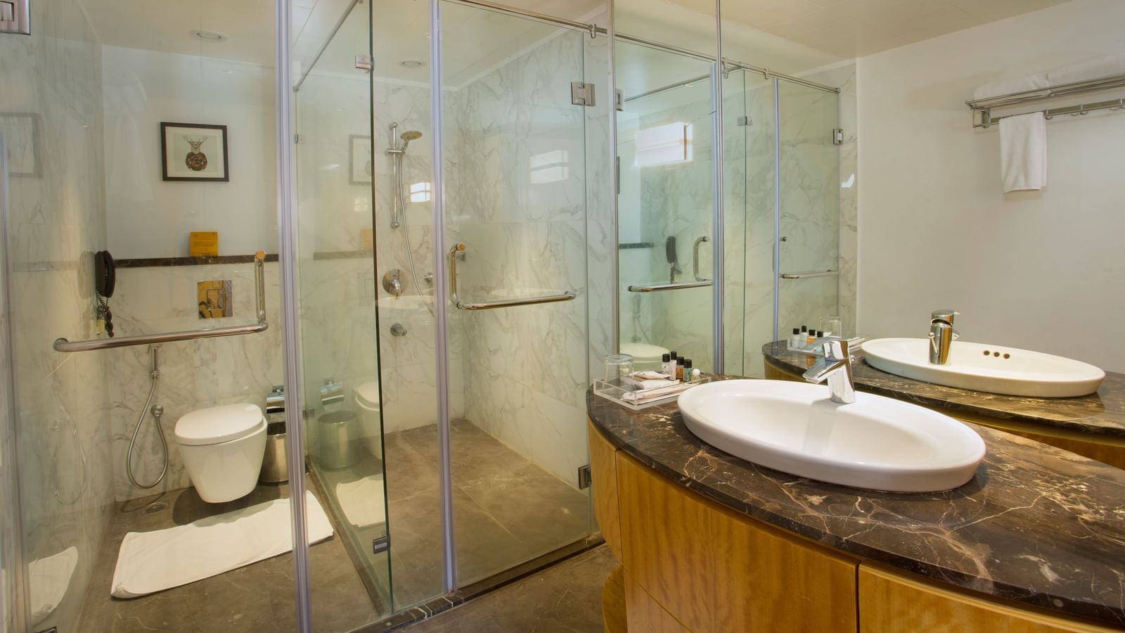 a washroom with a washbasin on the right and a western style toilet on the far end - Hotel Fountain Tree By TGI - JP Nagar, Bangalore