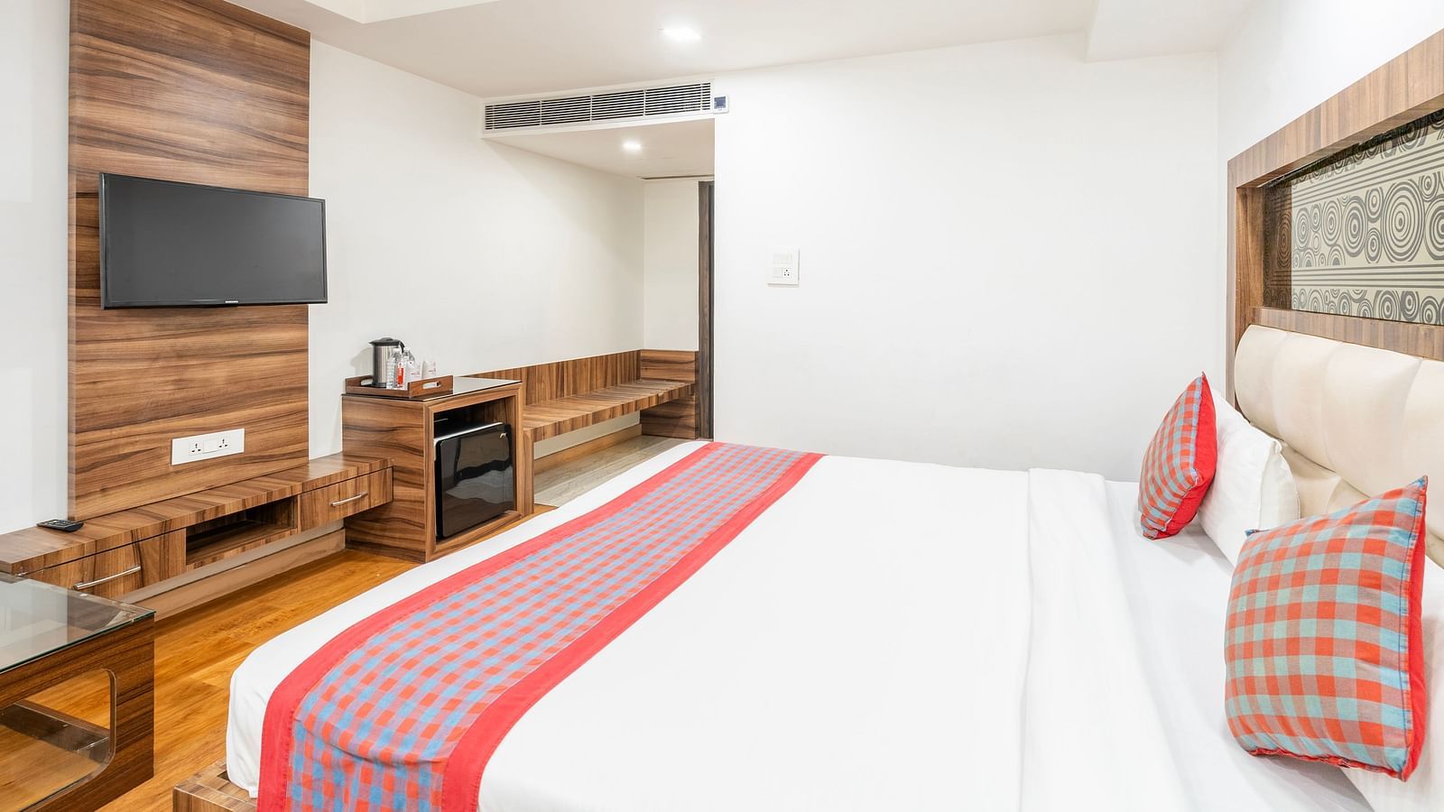 A head-on view of the bedroom at Hotel Moti Palace, focusing on the comfy bed