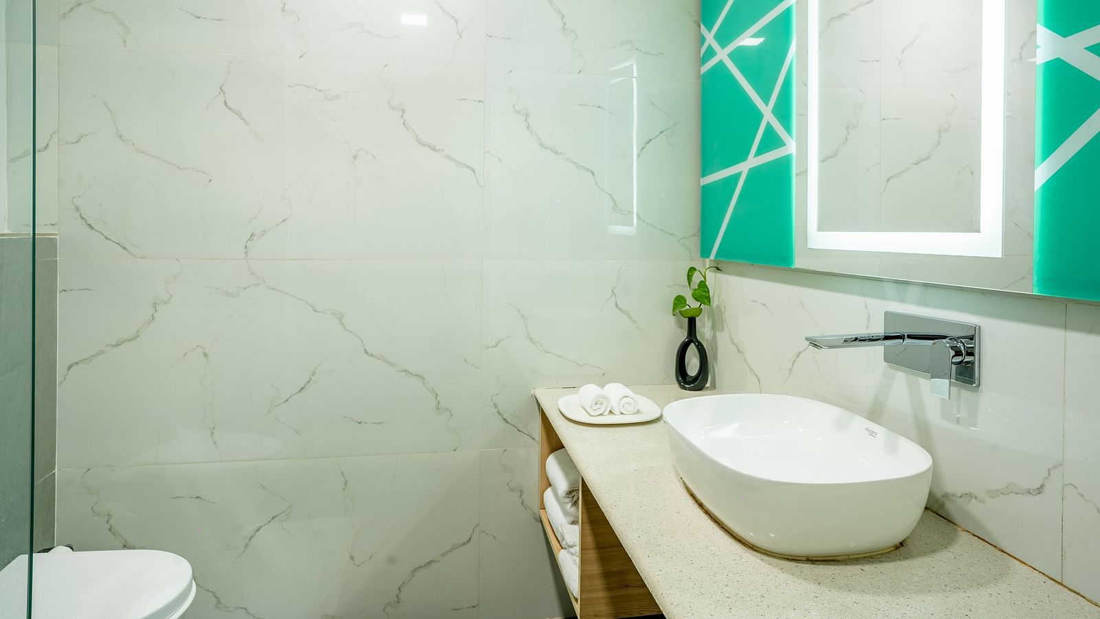 An image of a bathroom with a faucet and a sink | Inde Hotel Golf Course Extension