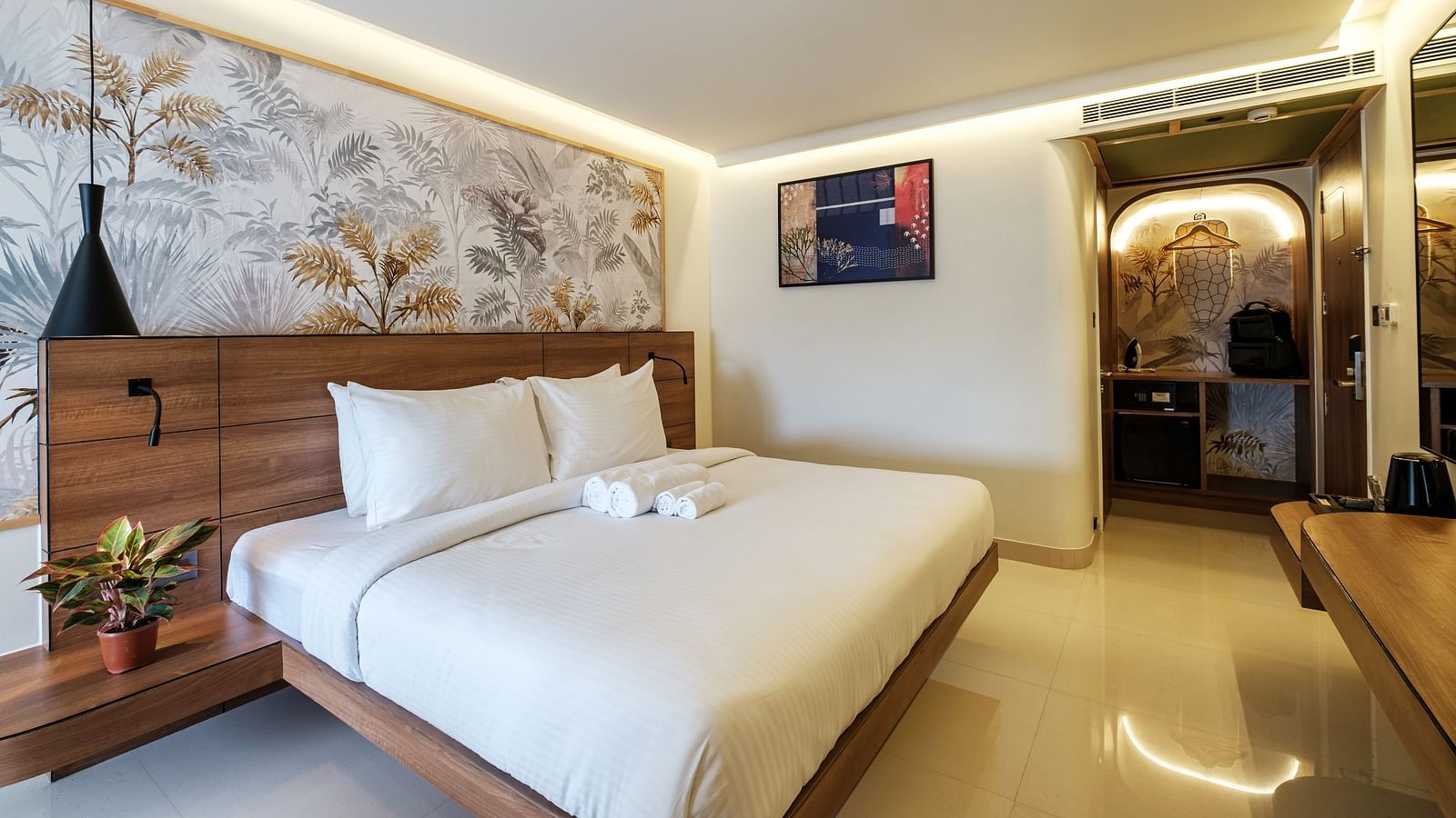 An image of bedroom featuring double size bed, a bedside table, and a hanging ceiling light in Indie Stays, Chembur.