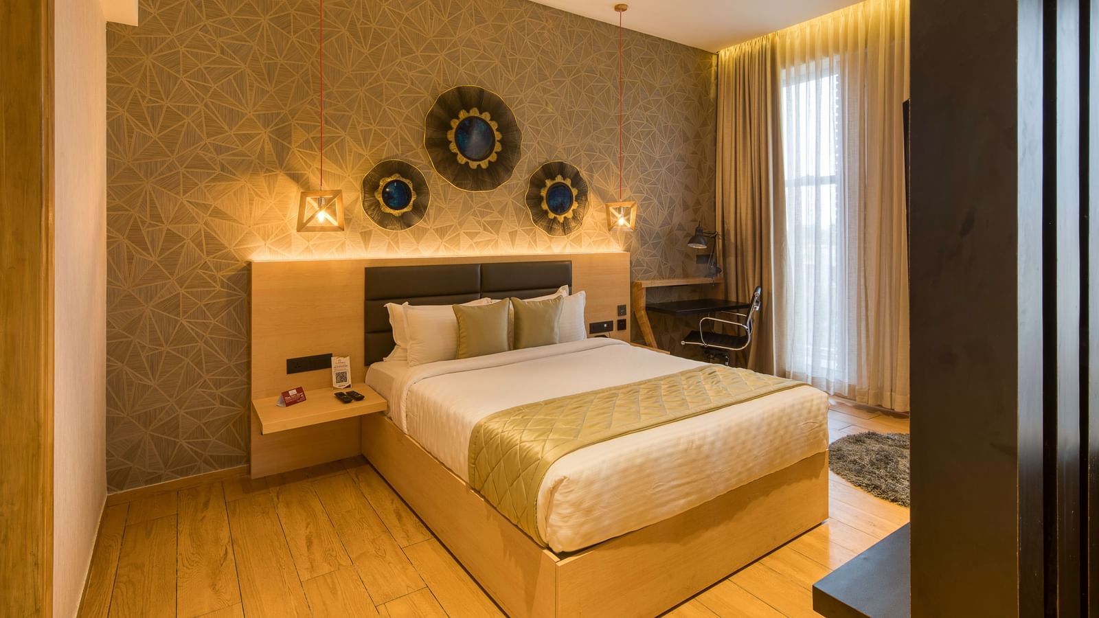 A double bed with golden bedsheets at Sumo Suite at Le Foliage by TGI, Bangalore