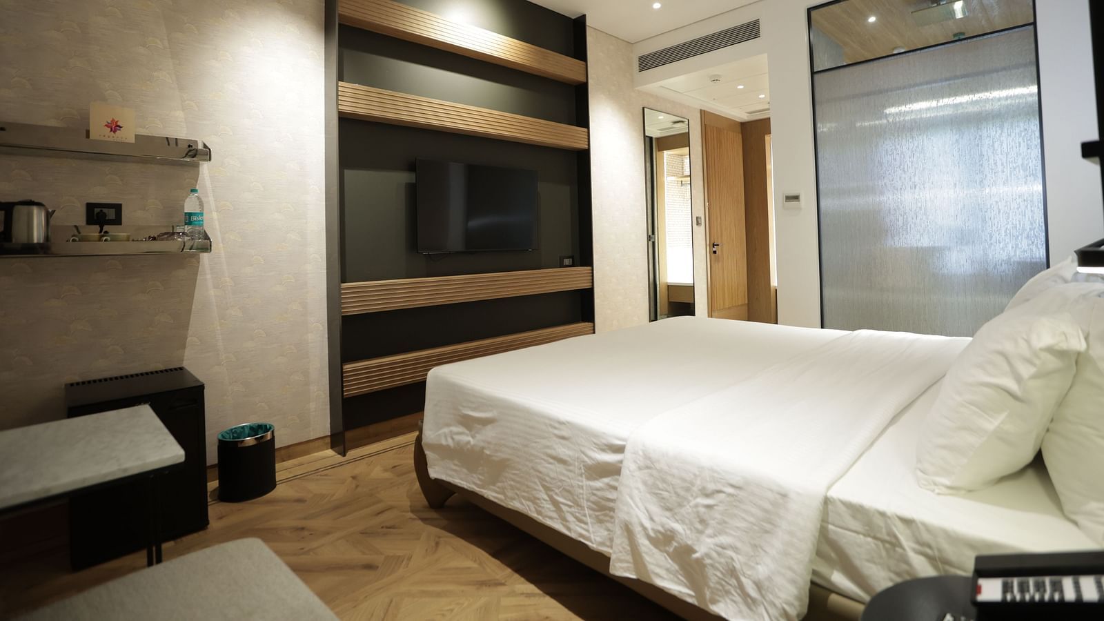 Premium accommodation at Regency Hotel, Mumbai featuring comfortable bedding, entertainment system, modern amenities and sophisticated interior design for guests.