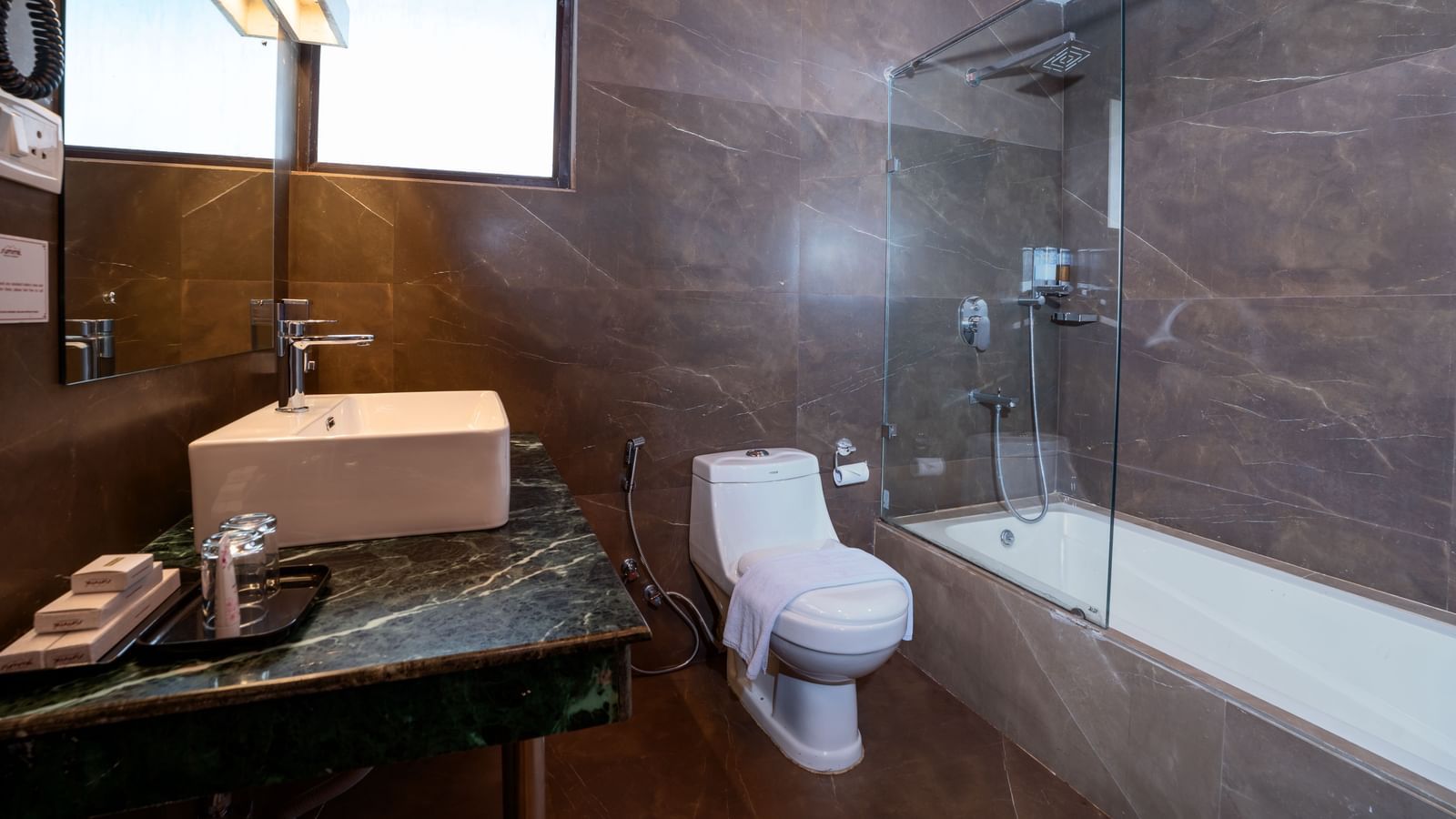 Suite with bathroom at Summit North Star, Gangtok featuring a wash basin, a faucet, a commode, and a  bathing tub.