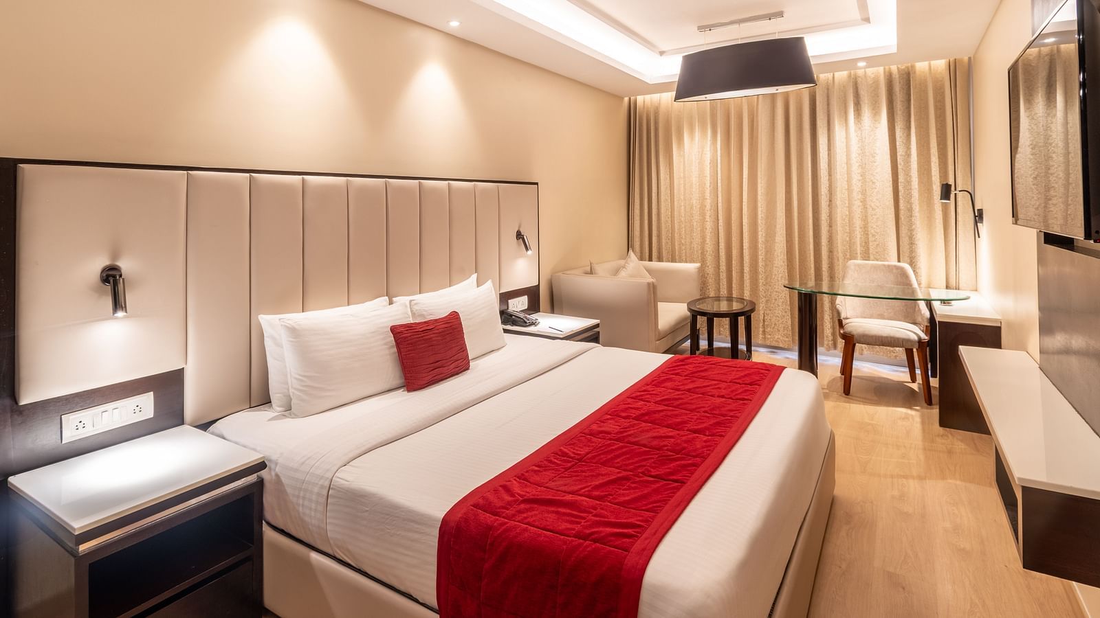Grand Suite with a huge bed, red accents, and soft ambient lighting,- TGI Grand Fortuna, Krishnagiri Main Road, Hosur