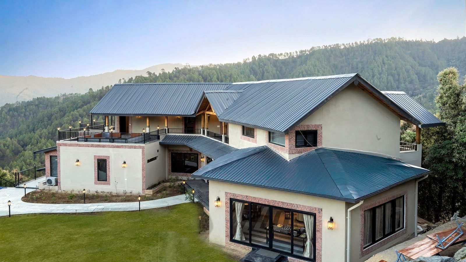 The Chamomile Estate's facade framed by the mountain and sky background.