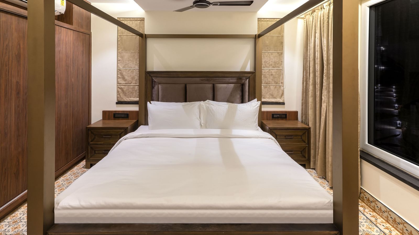 A double bed with wooden beams inside one of the rooms - The Tanisi Hotels & Resorts, Goa